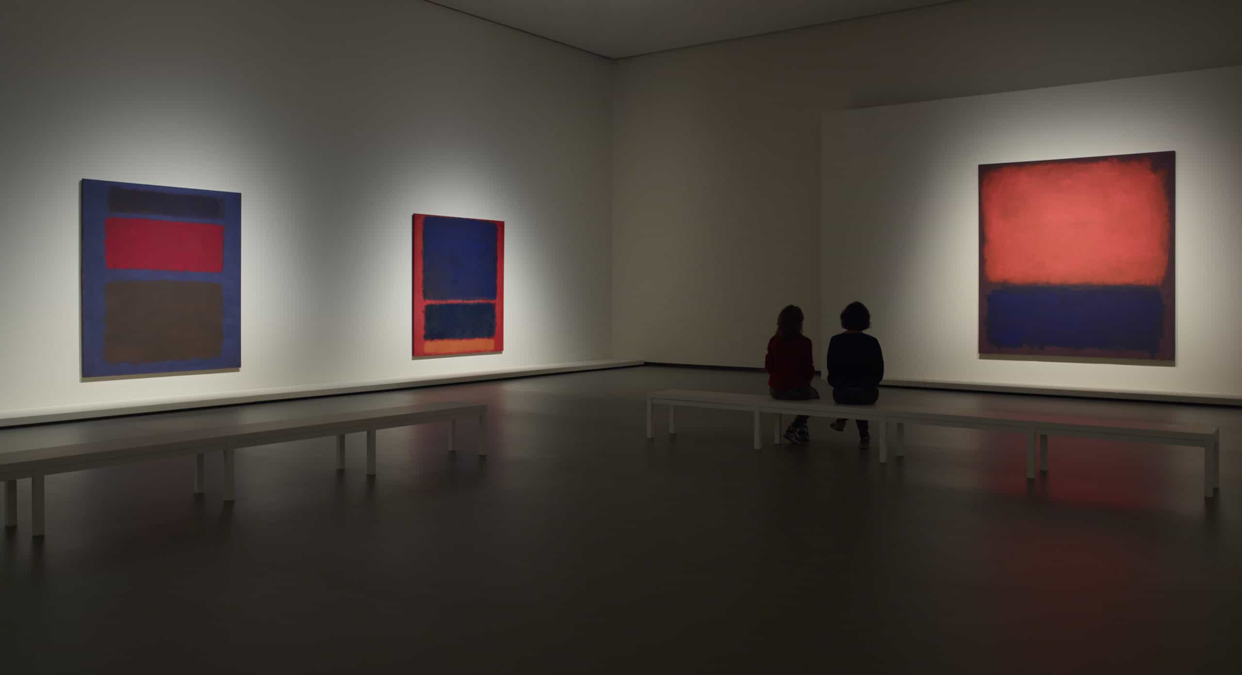 galerieruimte met drie werken van Mark Rothko en twee mensen die het werk aanschouwen